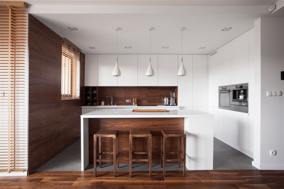 Open-concept kitchen with walnut cabinetry — representative example photo